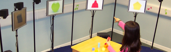 Child performing a task of sound localisation in loudspeaker 'Crescent of Sound'